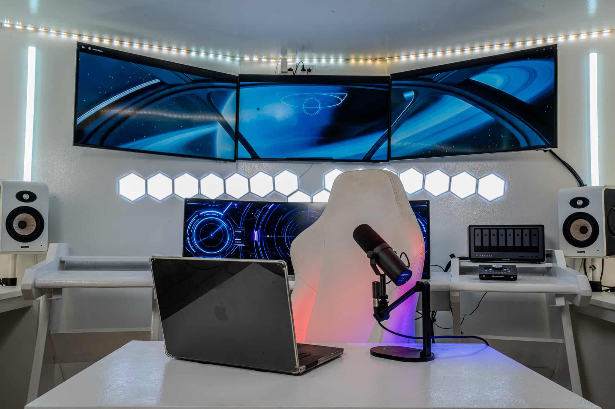 Modern Bangkok podcast studio with large screens, professional audio setup, and stylish lighting.