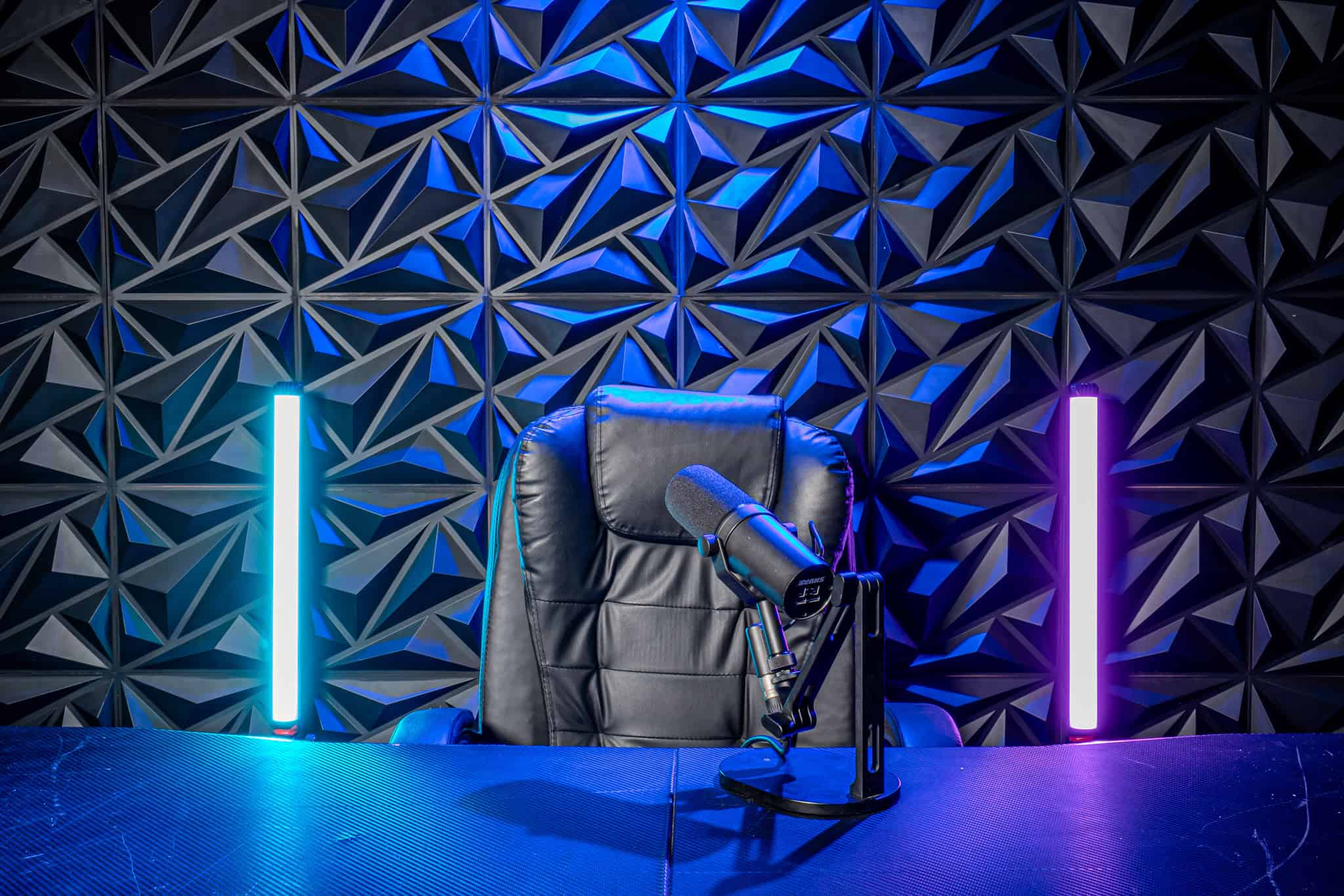 Studio podcast with professional microphone and acoustic panel background High-quality podcast and video recording studio setup with modern lighting and soundproof design.