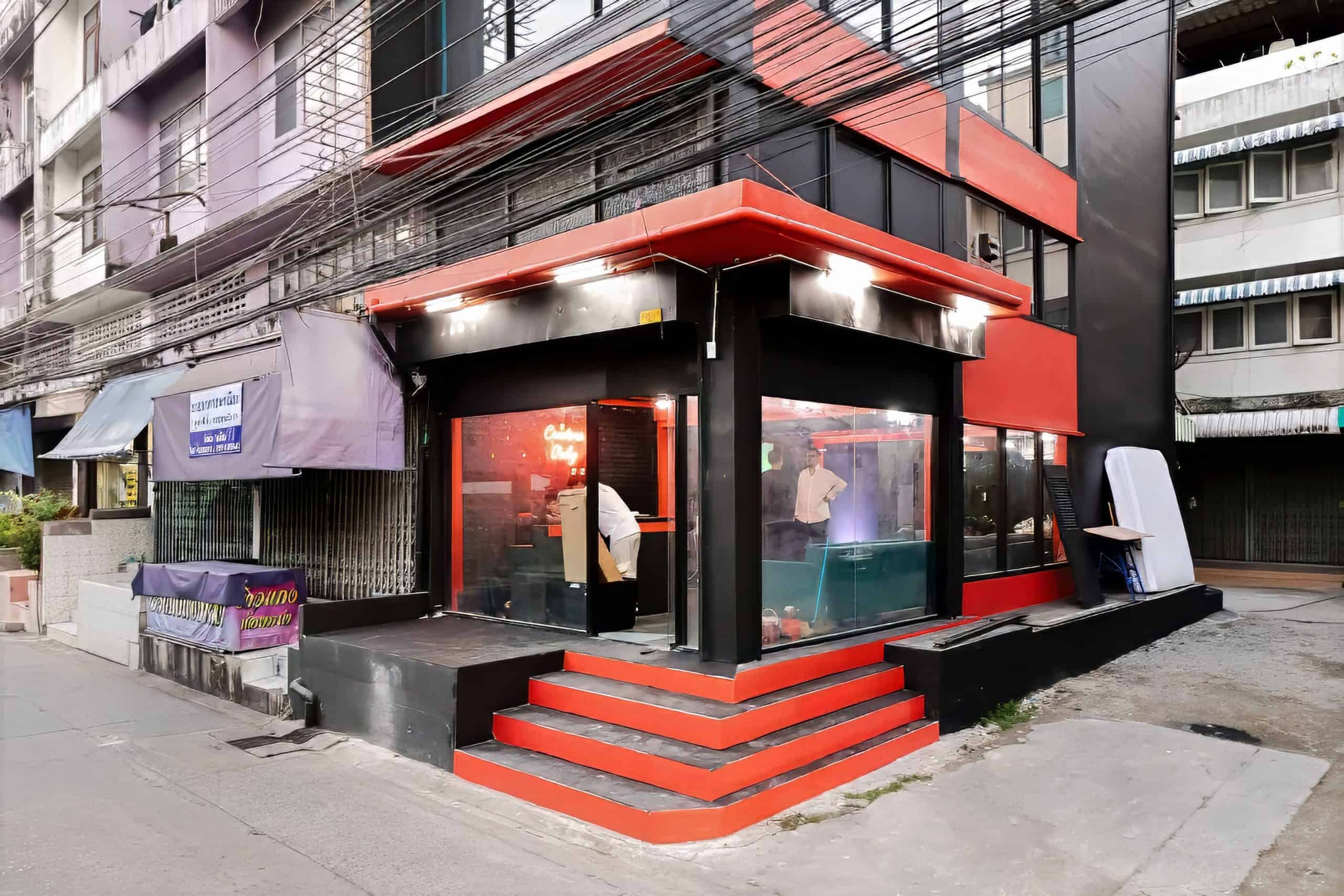 Modern podcast and video recording studio in Sukhumvit with sleek red and black design.