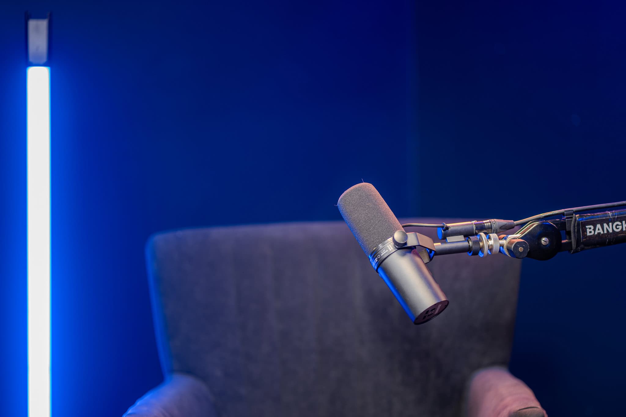 High-quality microphone setup in Bangkok podcast studio with soundproofing for clear audio.